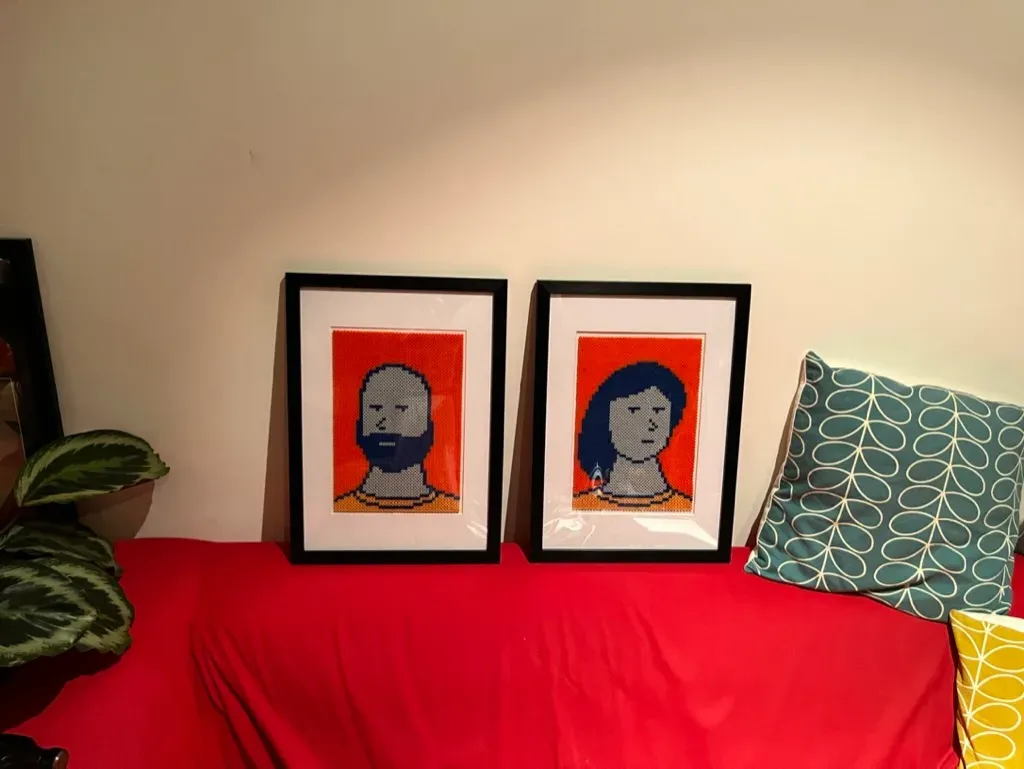 Two framed bead portraits of Luca and Ana on orange.