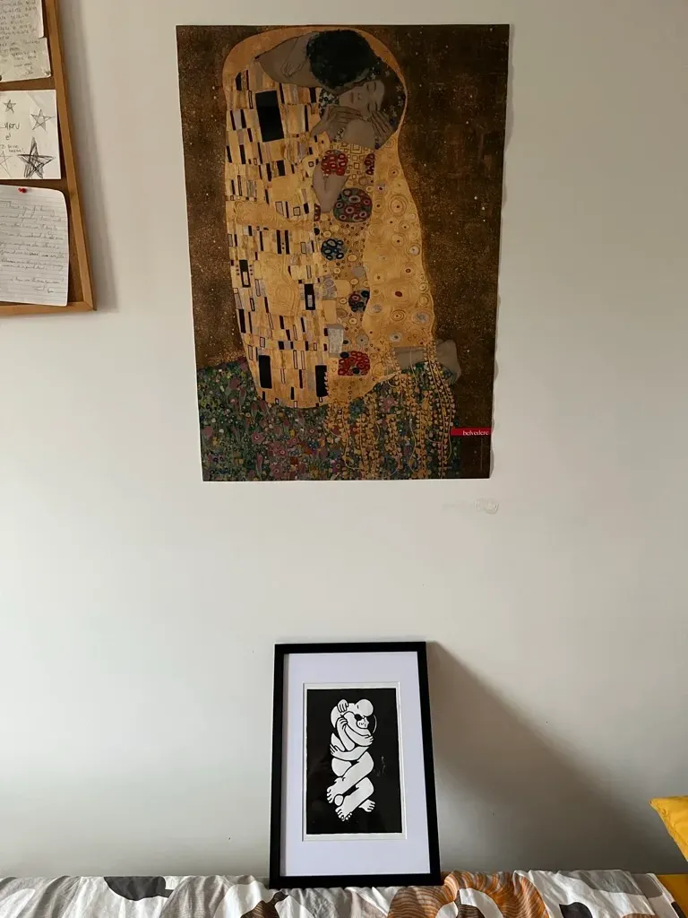 Ana's black and white Kiss, framed, under a poster of Klimt's original.